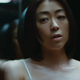 Hikaru Utada stands in front of a mirror in the video for the single "Pink Blood."
